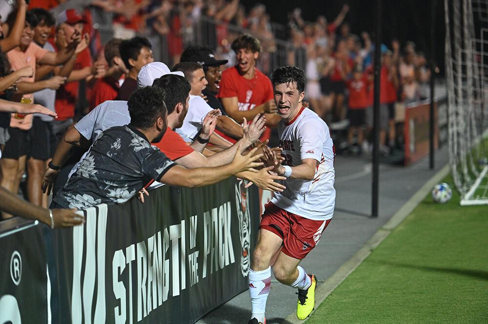 Graduate midfielder Conor Kelly celebrates with fans during the match against Wofford at Dail Soccer Field on Monday, Aug. 29, 2022. Kelly scored three goals. The Wolfpack won 4-0.