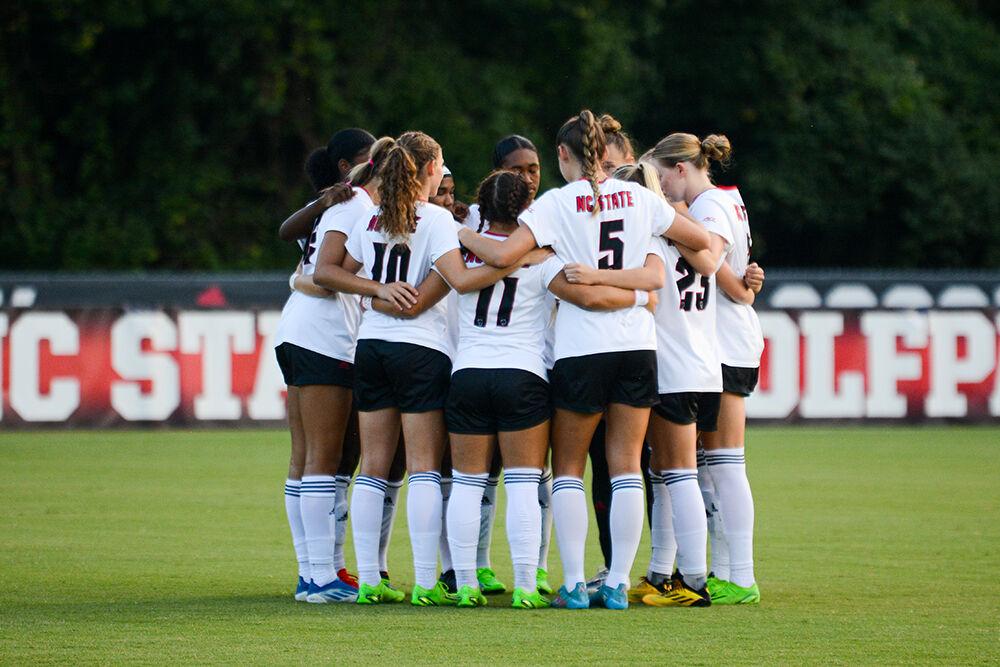 NC State women's soccer team huddles before the match against Georgetown on Sunday, Aug. 28, 2022 at Dail Soccer Field. The Wolfpack tied the match 2-2.