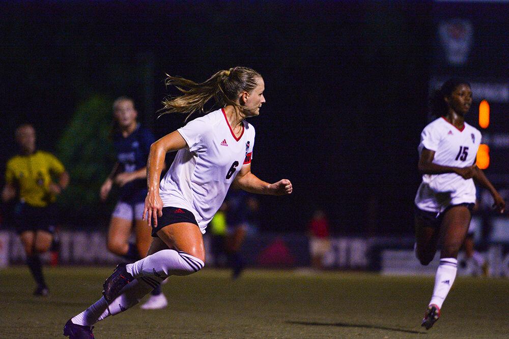 Graduate defender Lulu Guttenberg runs up the field during the women's soccer match against Georgetown at Dail Soccer Field on Sunday, Aug. 28, 2022. NC State tied with Georgetown 2-2.