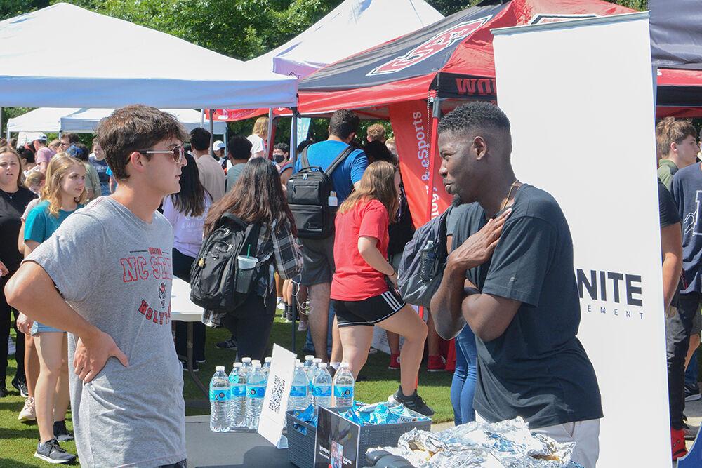 Niko Peele, from the Ignite movement, explains his group to Leo Mu&#241;oz, a first-year exploratory student at the Student Involvement Fair at Stafford Commons on Friday, Aug. 26, 2022. The Student Involvement Fair was an event that gave clubs and organizations the opportunity to come to NC State and interact with students.