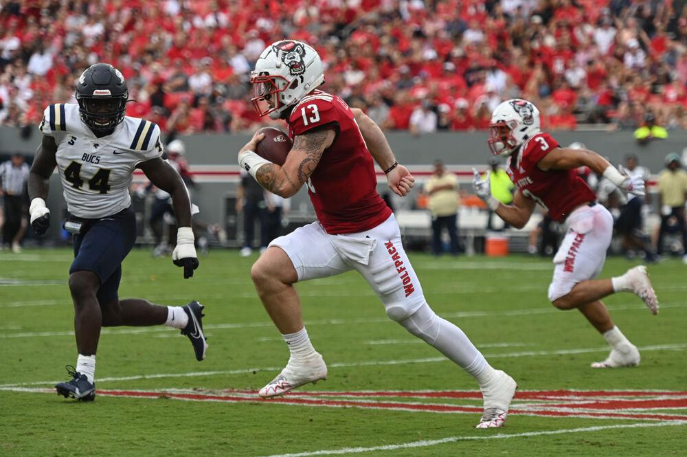 Redshirt junior quarterback Devin Leary rushes into the secondary during the Wolfpack's home football game against the Charleston Southern Buccaneers at Carter-Finley Stadium on Saturday, Sept. 10, 2022. Leary rushed for two touchdowns, threw four touchdowns and 238 yards as the Wolfpack beat the Buccaneers 55-3.
