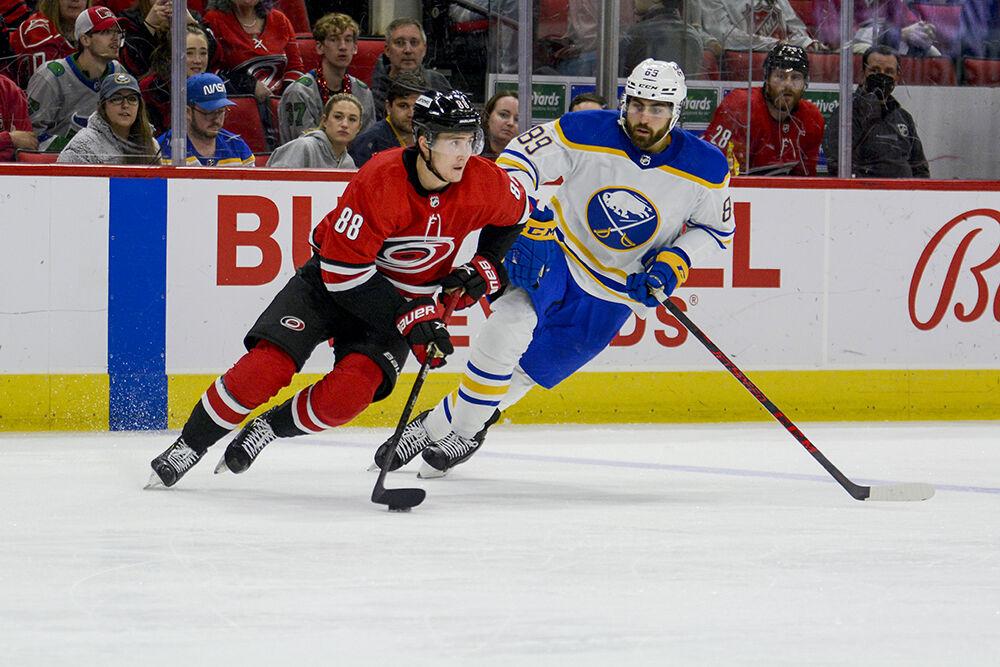 Carolina Hurricanes center, Martin Necas moves the puck with a defender in tow during the game against the Buffalo Sabres&#160;on Thursday, April 8, 2022 in PNC Arena. The Hurricanes beat the Sabres&#160;5-3.