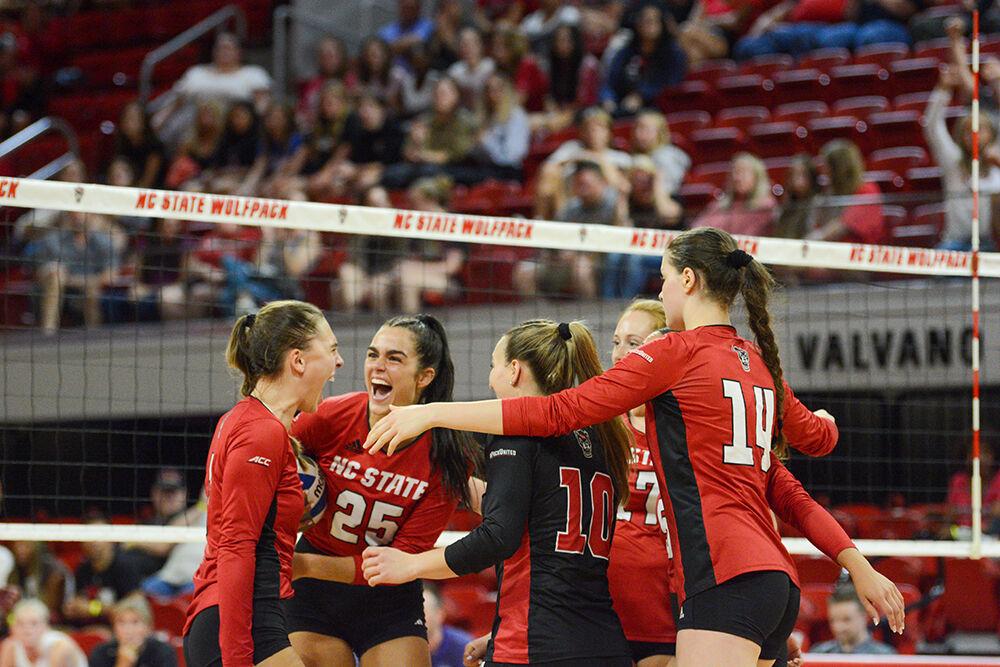 Members of the volleyball team celebrate a point in the game against TCU on Friday, Sept. 9, 2022 in Reynolds Coliseum. The Wolfpack beat the Horned Frogs 3-0.