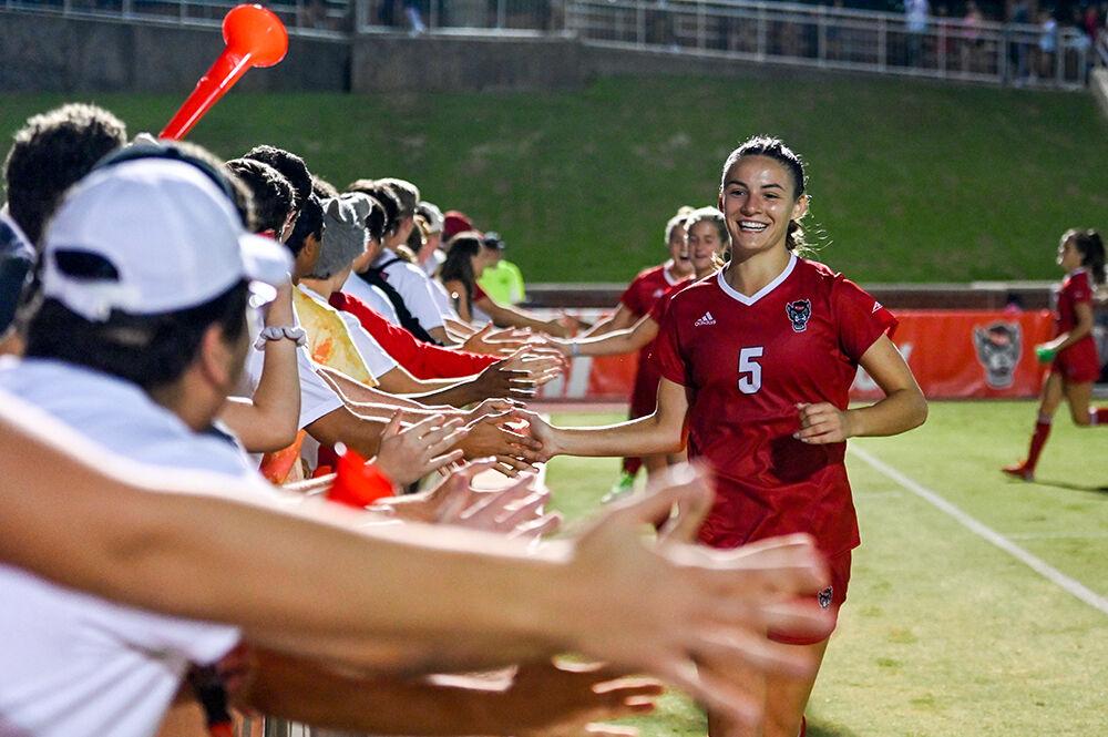 Graduate defender Jenna Butler high-fives the crowd at the conclusion of the match against Wake Forest on Sunday, Sept. 18, 2022 at Dail Soccer Field. Butler made one assist for the Wolfpack. NC State beat Wake Forest 2-1.