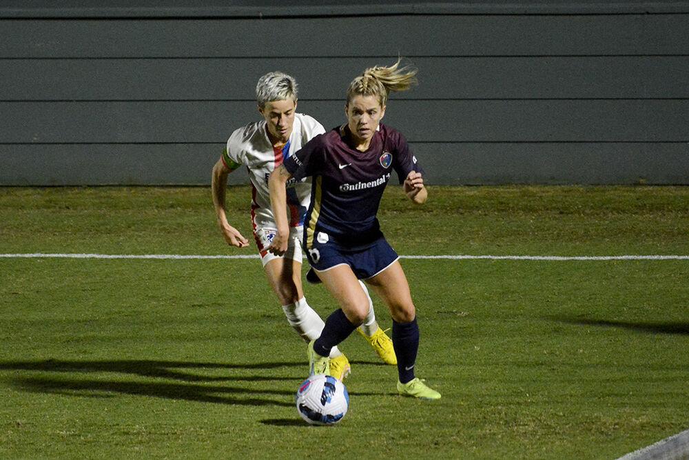 Courage midfielder Denise O'Sullivan escapes a corner press by Reign forward Megan Rapinoe during the NC Courage match against OL Reign on Friday, Sept. 17, 2022. OL Reign won the match 2-1.