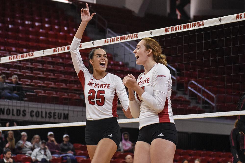 Junior middle blocker Riley Shaak, left, and sophomore opposite hitter Amanda Rice celebrate a scored point during the game against Florida State on Friday, Sept. 30, 2022 at Reynolds Coliseum. Shaak and Rice each made five kills for the Wolfpack. NC State beat Florida State 3-0.