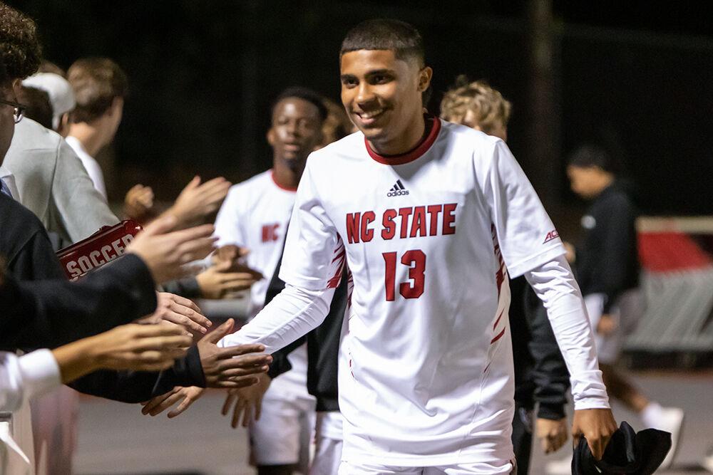 Freshman midfielder Calem Tommy high-fives the crowd at the conclusion of the match against Virginia Tech on Friday, Sept. 23, 2022 at Dail Soccer Field. NC State beat Virginia Tech 1-0.