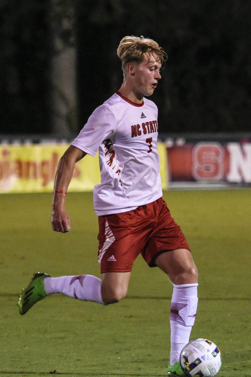 Sophomore defender Jarvis Cleal passes the ball during the match against James Madison on Tuesday, Sept. 13, 2022 at Dail Soccer Field. NC State lost 1-0 to James Madison.