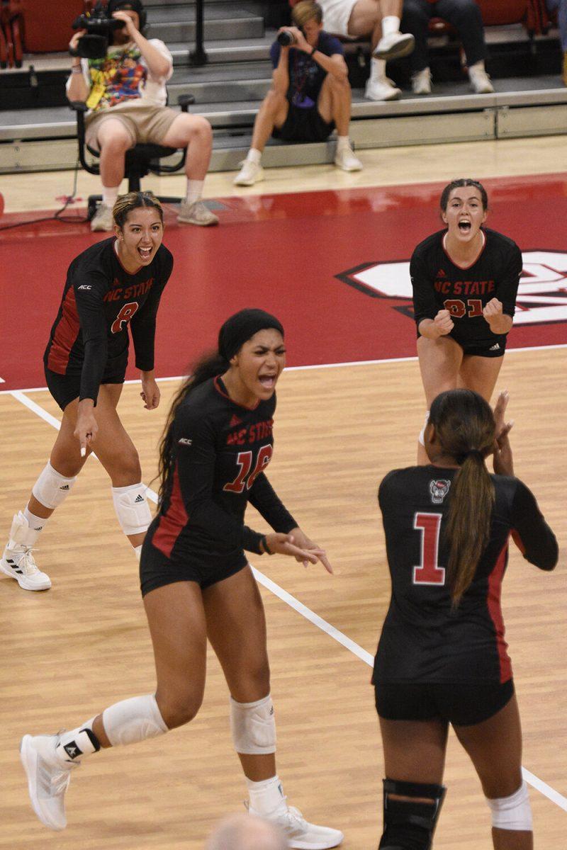 The team celebrates a point earned in the match versus WCU on Friday, Sept. 9, 2022 in Reynolds Coliseum. NC State suffered a 3-0 loss to the Catamounts.