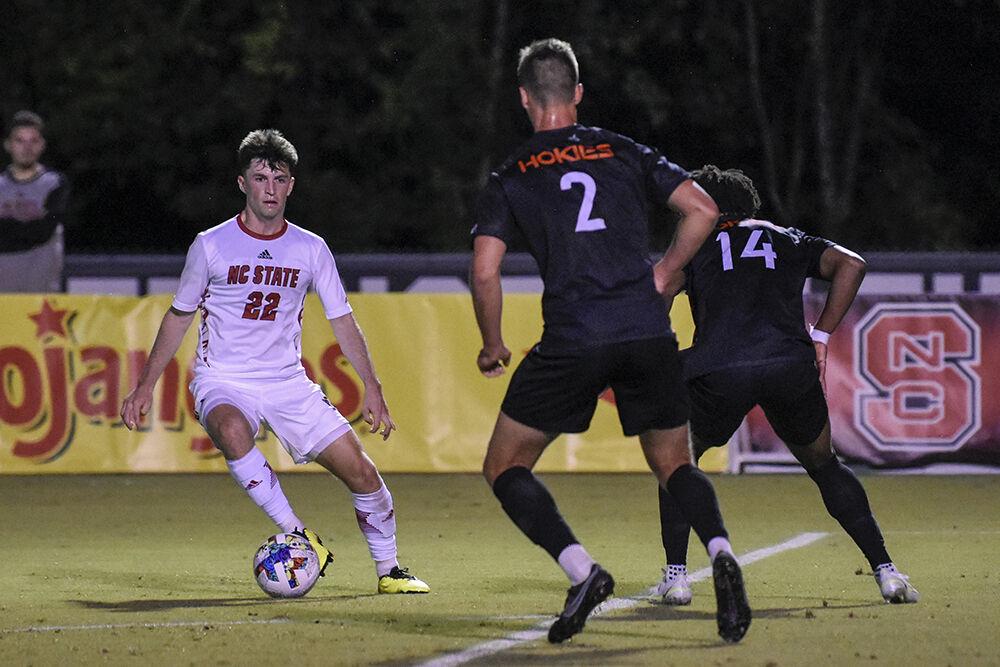 Graduate midfielder Conor Kelly dribbles the ball away from an opponent during the match against Virginia Tech on Friday, Sept. 23, 2022 at Dail Soccer Field. Kelly attempted one shot on the goal. NC State beat Virginia Tech 1-0.