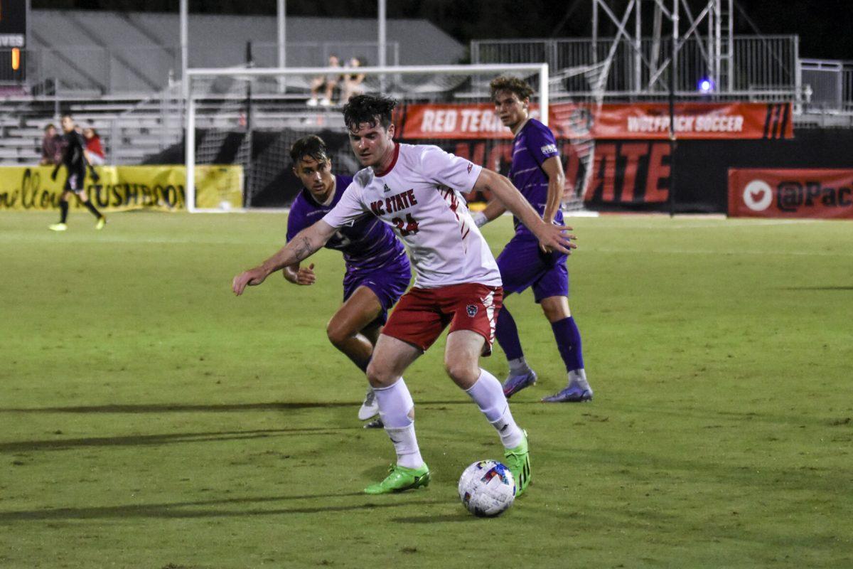 Senior defender Cam Murray dribbles the ball away from an opponent during the match against James Madison on Tuesday, Sept. 13, 2022 at Dail Soccer Field. NC State lost 1-0 to James Madison.