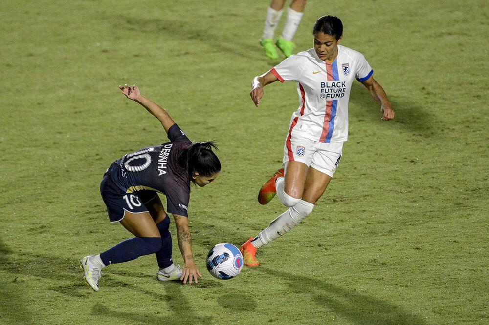 Courage midfielder Debinha evades Reign defender Alana Cook during the NC Courage match against OL Reign on Friday, Sept. 17, 2022. OL Reign won the match 2-1.
