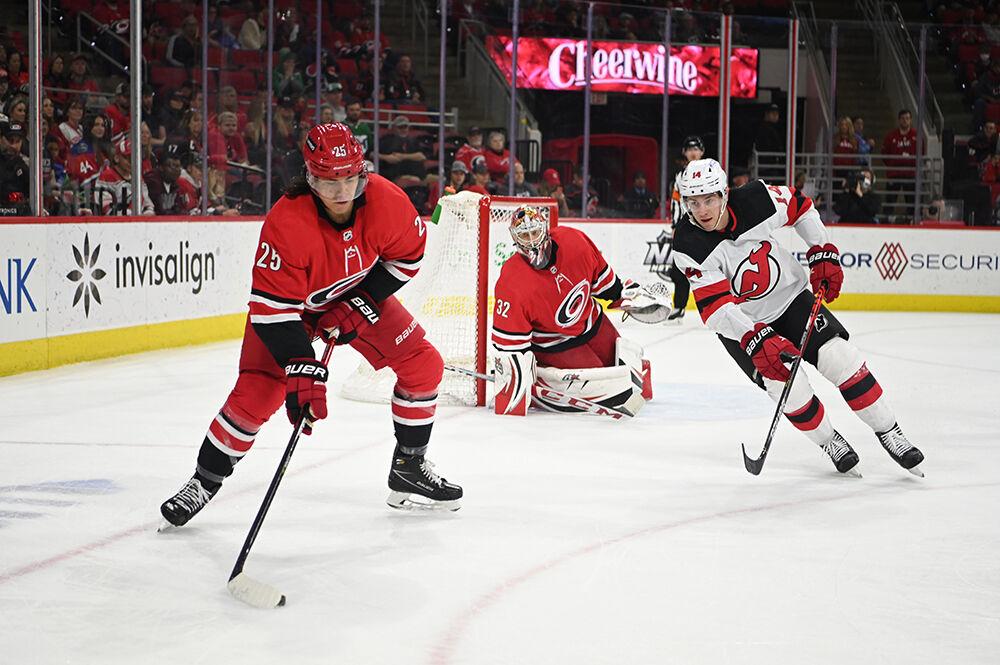 Right defenseman Ethan Bear passes the puck during the game in PNC Arena on Thursday, April 28, 2022. The Hurricanes beat the Devils 6-3.