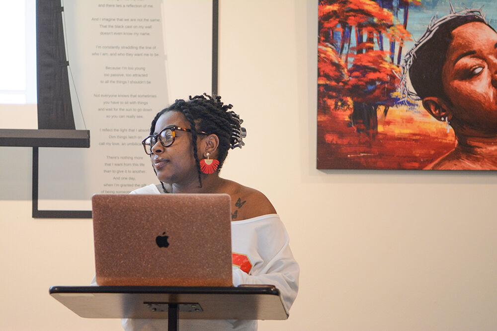 Alexis Lawson, a freelance writer, leads a writing exercise during the HerBlackHand Poetry Workshop in the African American Cultural Center Gallery on Friday, Sept. 16, 2022.