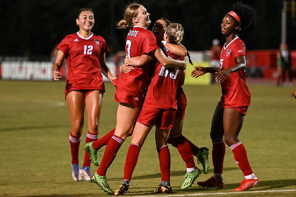Members of the NC State women's soccer team celebrate scoring a goal during the match against Wake Forest on Sunday, Sept. 18, 2022 at Dail Soccer Field. NC State beat Wake Forest 2-1.