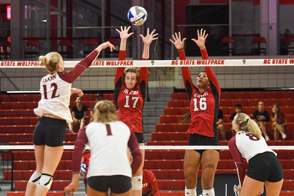 Sophomore opposite hitter Amanda Rice (left) and sophomore middle blocker Jada Allen (right) block the ball in the game against Elon on Saturday, Sept. 3, 2022 in Reynolds Coliseum. NC State won 3-1.