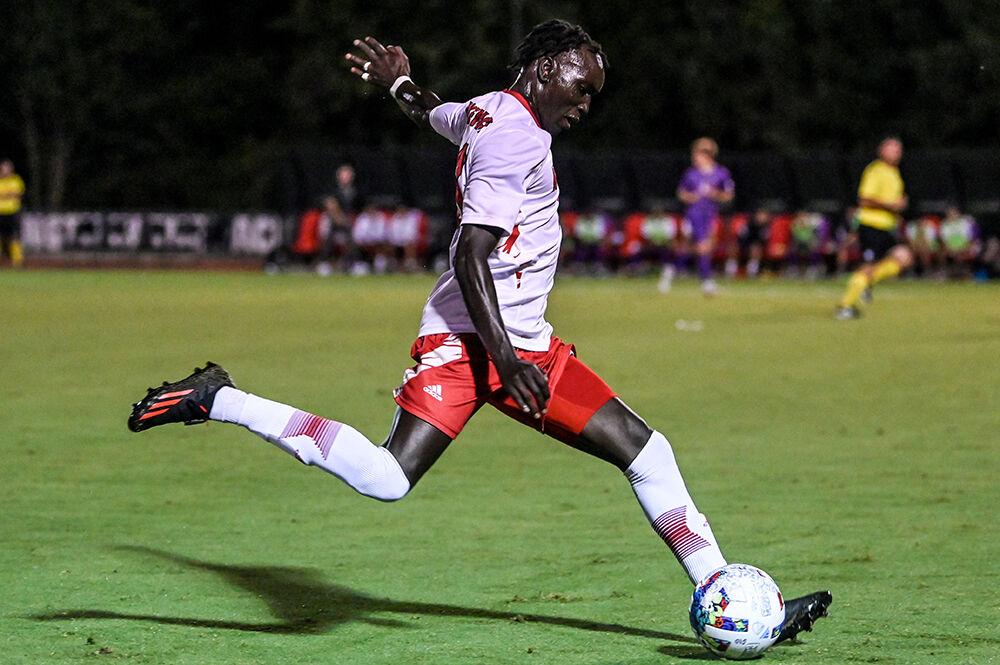 Senior forward Jeremiah Luoma kicks the ball during the match against James Madison on Tuesday, Sept. 13, 2022 at Dail Soccer Field. Luoma made one shot attempt for the Wolfpack. NC State lost 1-0 to James Madison.