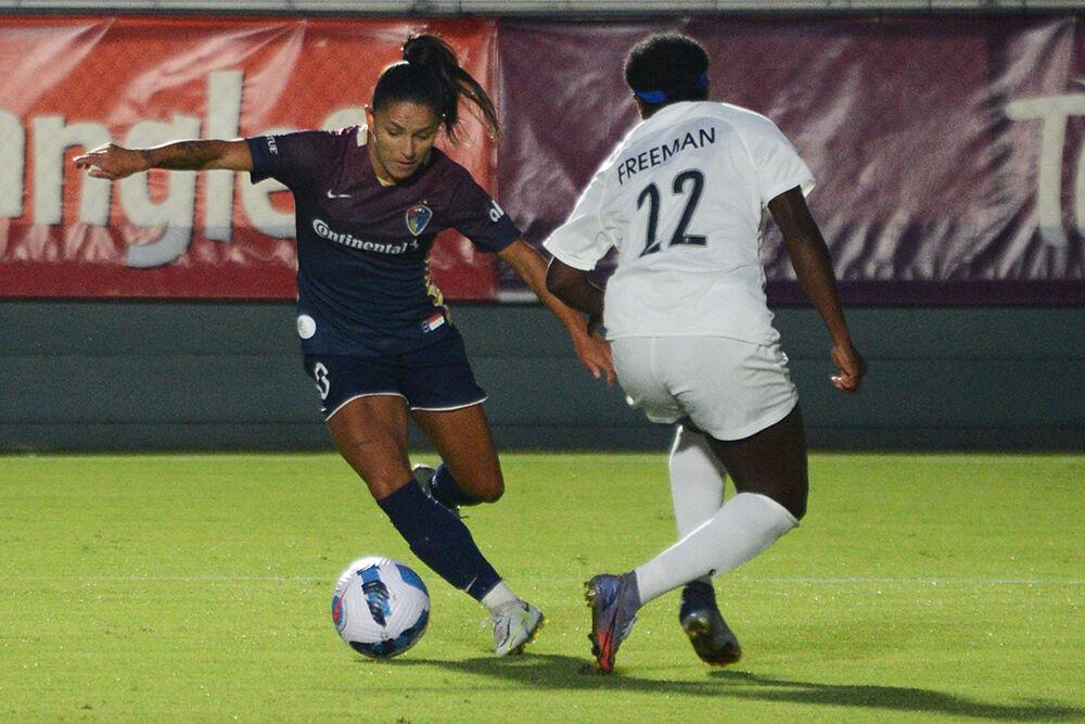North Carolina Courage midfielder Debinha evades Gotham FC defender Mandy Freeman during the match on Saturday, Sept. 24, 2022 in Sahlen's Stadium at WakeMed Soccer Park. NC Courage won 3-0.
