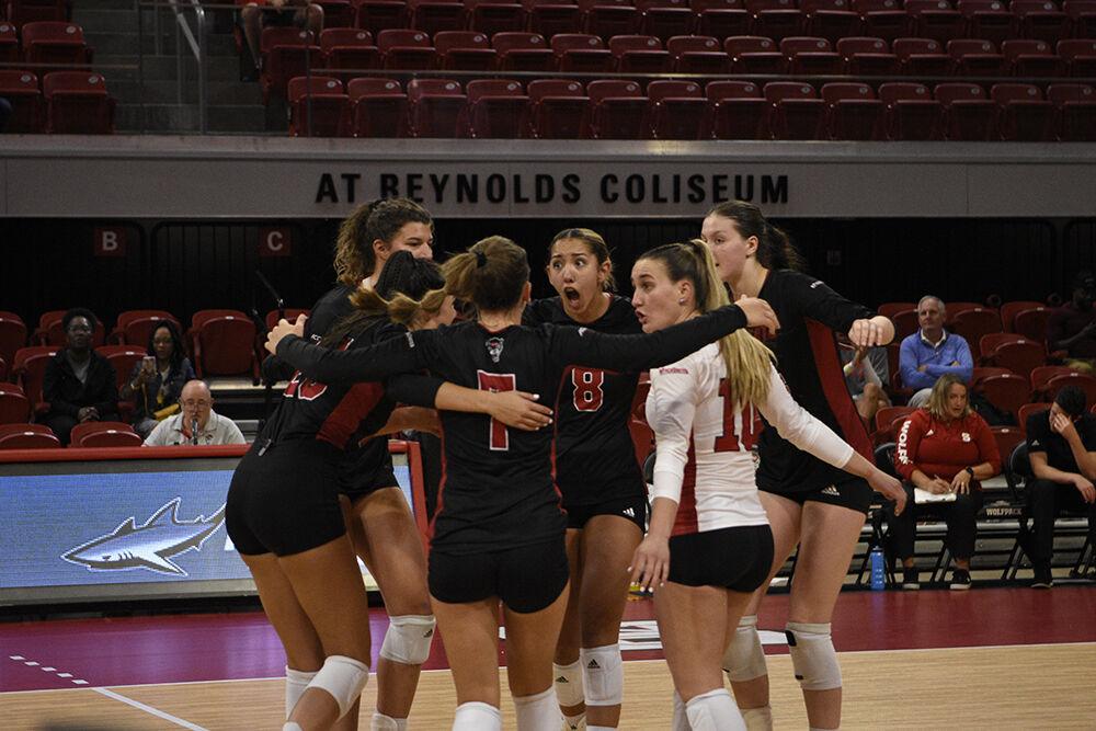 The NC State volleyball team celebrates a point earned in the match against WCU on Friday, Sept. 9, 2022 in Reynolds Coliseum. NC State lost 3-0.