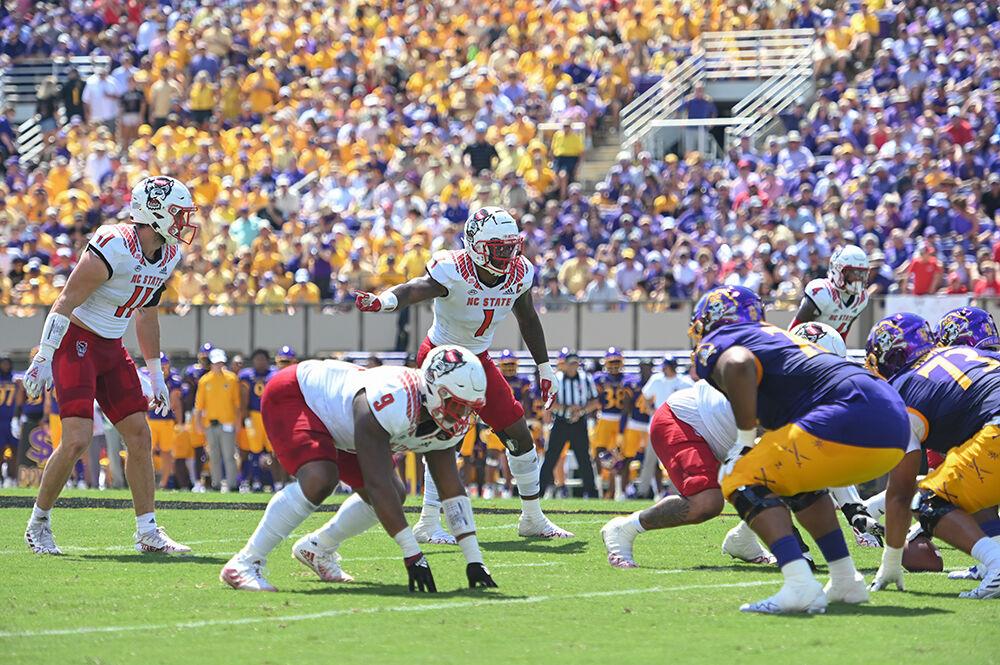 Graduate linebacker Isaiah Moore gives directions to the Wolfpack defense during the football game against East Carolina at Dowdy-Ficklen Stadium on Saturday, Sept. 3, 2022. The Wolfpack beat the Pirates 21-20.