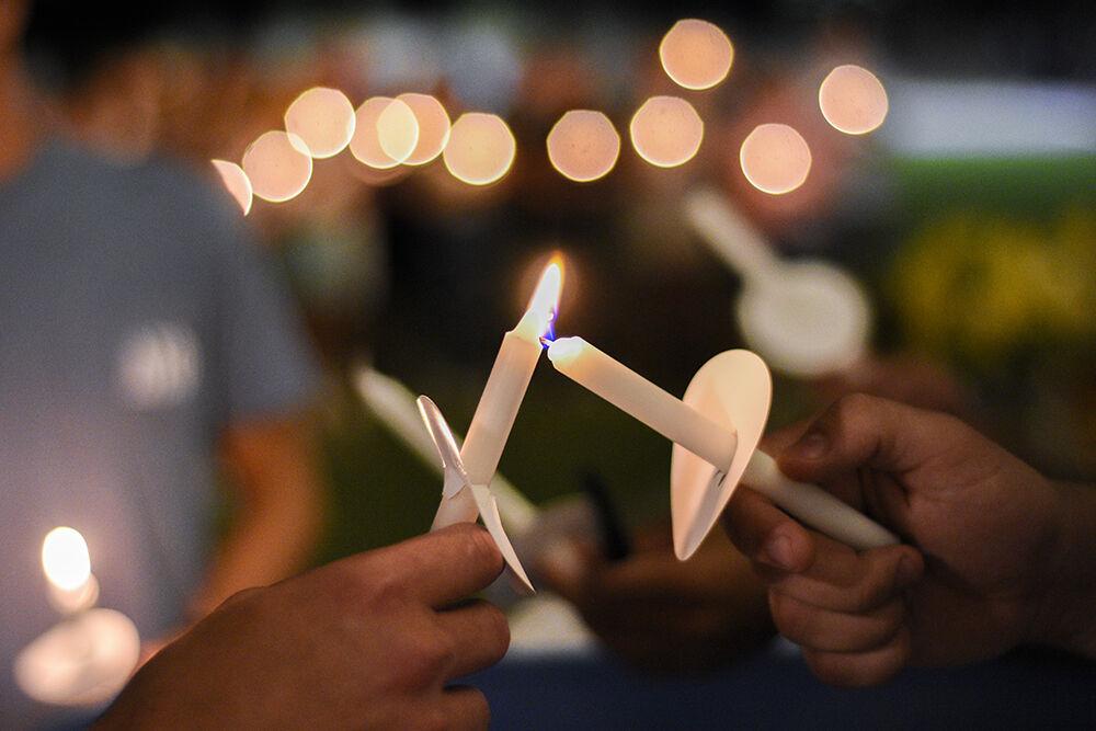 Members of the NC State community light candles at the vigil for Ryan Bohner on Stafford Commons on Sept. 21, 2022. Bohner was an NC State student and a member of Delta Sigma Phi.