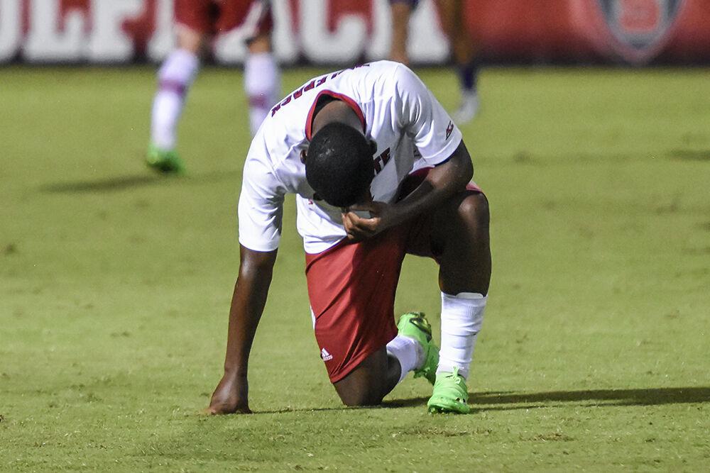 Sophomore midfielder Vusumzi Plamana kneels at the end of the match against James Madison on Tuesday, Sept. 13, 2022 at Dail Soccer Field. NC State lost 1-0 to James Madison.
