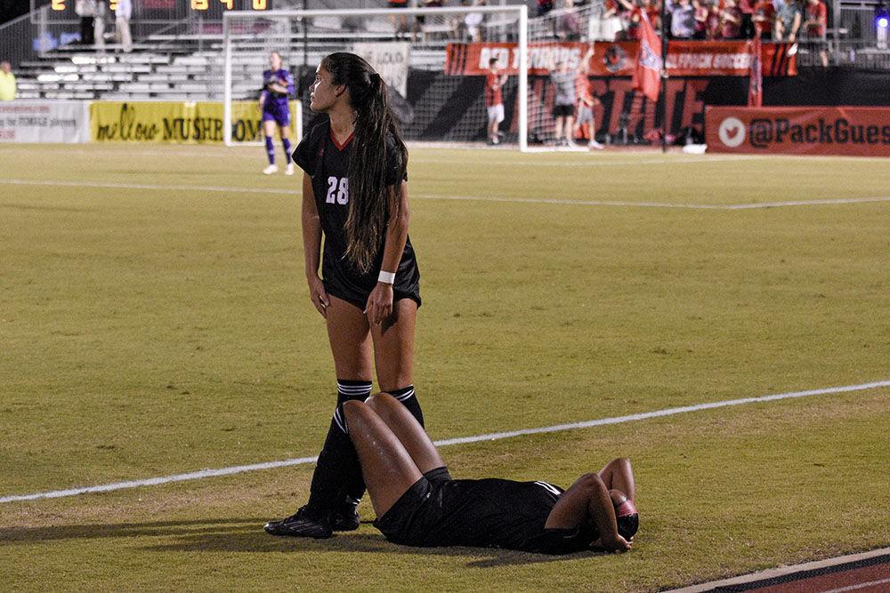 Sophomore defender Kayla Siddiqi (back) calls for the attention of health officials after sophomore forward Brianna Holt is injured during the match against the Blue Devils at Dail Soccer Field on Sunday, Sept. 25, 2022. NC State lost 6-0.