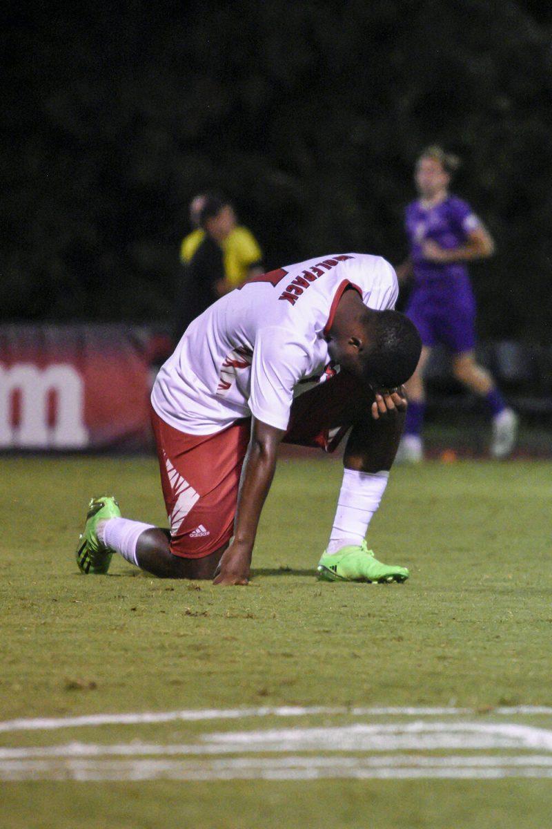 Sophomore midfielder Vusumzi Plamana kneels at the conclusion of the match against James Madison on Tuesday, Sept. 13, 2022 at Dail Soccer Field. NC State lost 1-0 to James Madison.