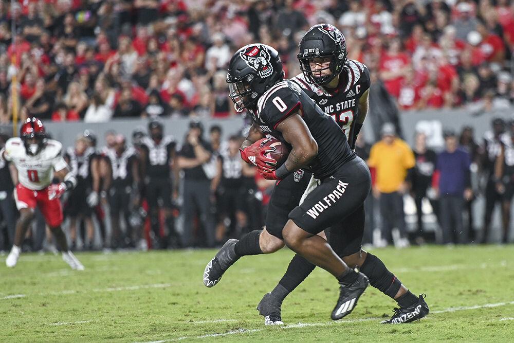 Redshirt junior quarterback Devin Leary hands the ball off to sophomore running back Demie Sumo-Karngbaye during the football game against Texas Tech at Carter-Finley Stadium on Saturday, Sept. 17, 2022. NC State beat Texas Tech 27-14.