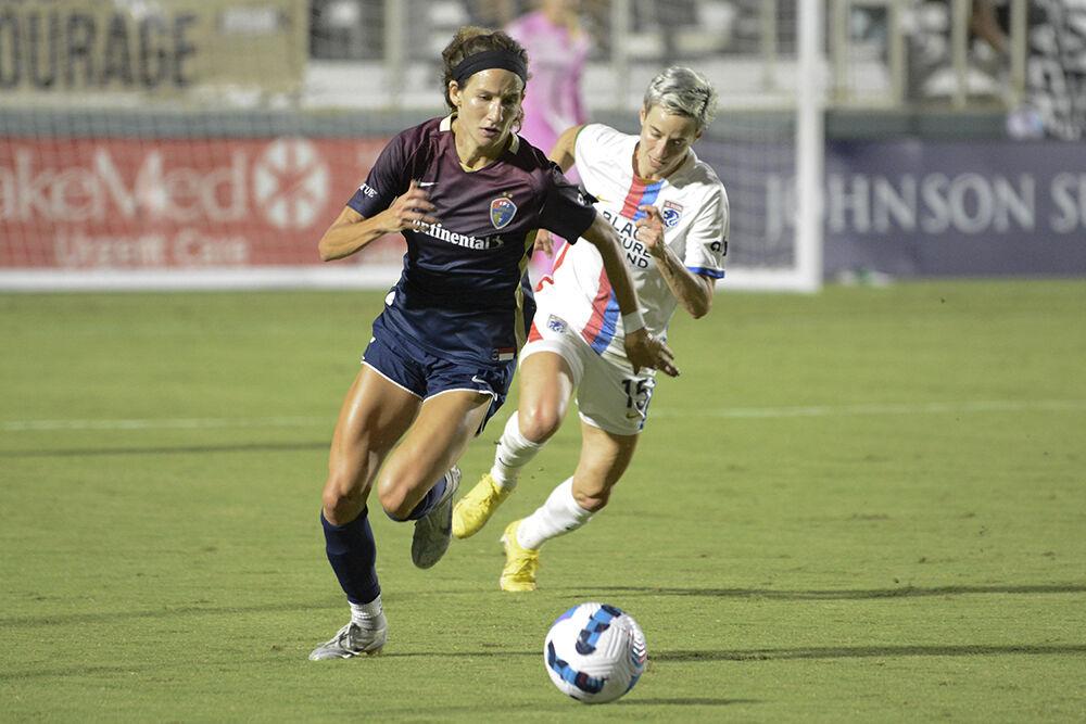 Courage defender Ryan Williams dribbles away from Reign forward Megan Rapinoe during the NC Courage match against OL Reign on Friday, Sept. 17, 2022. OL Reign won the match 2-1.