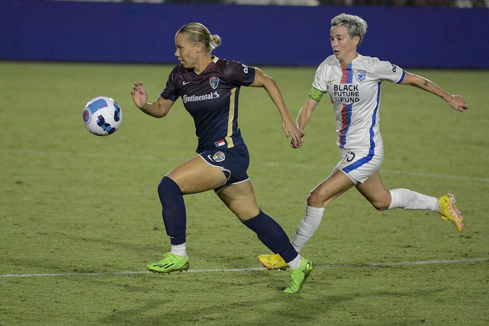 Courage defender Merritt Mathias outruns Reign forward Megan Rapinoe during the NC Courage match against OL Reign on Friday, Sept. 17, 2022. OL Reign won the match 2-1.
