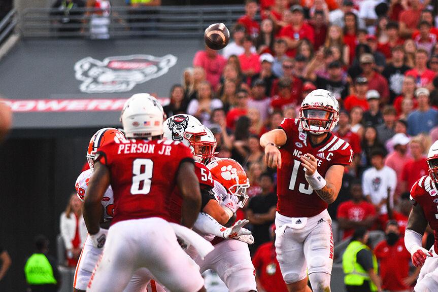 Redshirt sophomore quarterback Devin Leary throws the ball to junior running back Ricky Person Jr. in the game against Clemson on Saturday, Sept. 25, 2021 in Carter-Finley Stadium. Leary had 238 running yards in game and Person Jr. had 91 rushing yards. NC State beat Clemson 27-21 in double overtime.