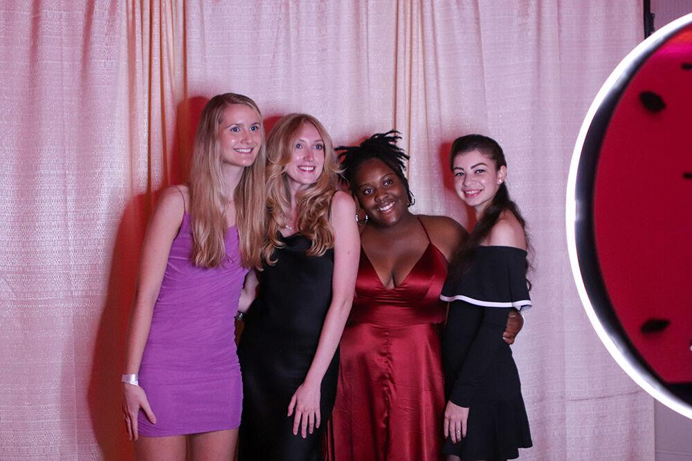 (From left) Chloe Simmons, a second-year studying marketing, Quinn Shopbell, a fourth-year studying finance, Zakiyah McCullough, a third-year studying plant biology and Hana Khalil, a fourth-year studying architecture, take a photo in the photo booth at the Red and White Ball in Talley Student Union on Saturday, Oct. 22, 2022.