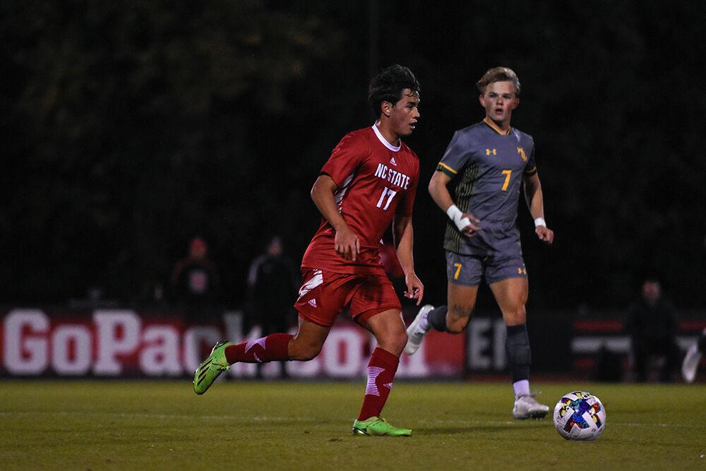 Freshman midfielder Caden Tolentino dribbles the ball during the Wolfpack's home soccer match against the William &amp; Mary Tribe on Tuesday, Oct. 18, 2022 at Dail Soccer Field. The Wolfpack beat the Tribe 2-1.