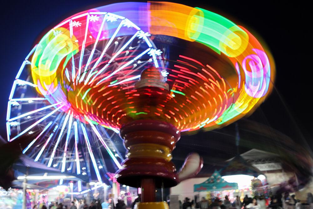 The Lollipop Swings ride spins fairgoers at the North Carolina State Fair in Raleigh on Friday, Oct. 21, 2022.