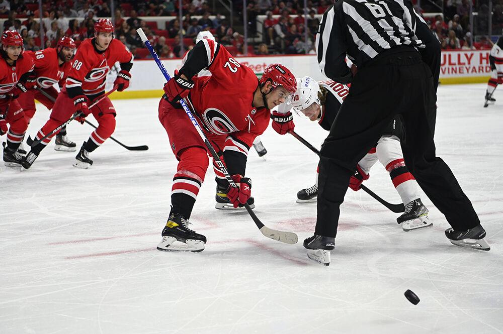 Center Jesperi Kotkaniemi goes against a New Jersey Devil player during the game in PNC Arena on Thursday, April 28, 2022. The Hurricanes beat the Devils 6-3.
