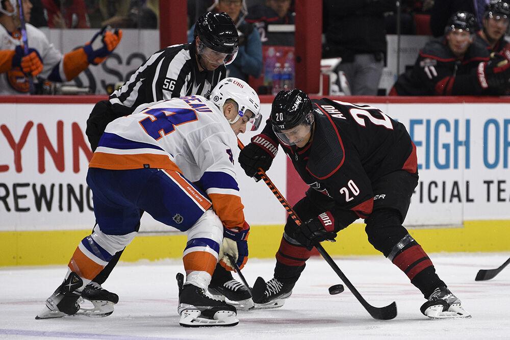 Center Sebastian Aho faces off against a New York Islanders opponent during the game in PNC Arena on Friday, Oct. 28, 2022. The Hurricanes lost 6-2. Aho had 11 faceoff wins. The Hurricanes lost 6-2.