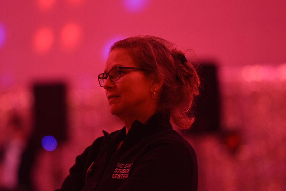 Suzanne Pierce, UAB event coordinator, watches students dance at the Red &amp; White Ball on Saturday, Oct. 22, 2022 at Talley Student Union. The Red &amp; White Ball was NC State's annual formal dance and was hosted by the University Activities Board.