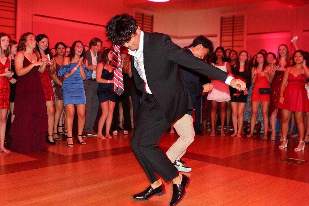 (Left) Joshua Hernandez, a second-year studying civil engineering and Jason Voltz, a second-year studying business, dance in the dance circle at the Red and White Ball in Talley Student Union on Saturday, Oct. 22, 2022.
