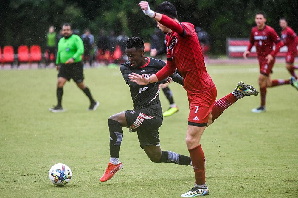 Junior forward Junior Nare dribbles the ball down the field during the match against Louisville on Friday, Sept. 30, 2022 at Dail Soccer Field. Nare made one shot for the Wolfpack. NC State lost 1-0 to Louisville.