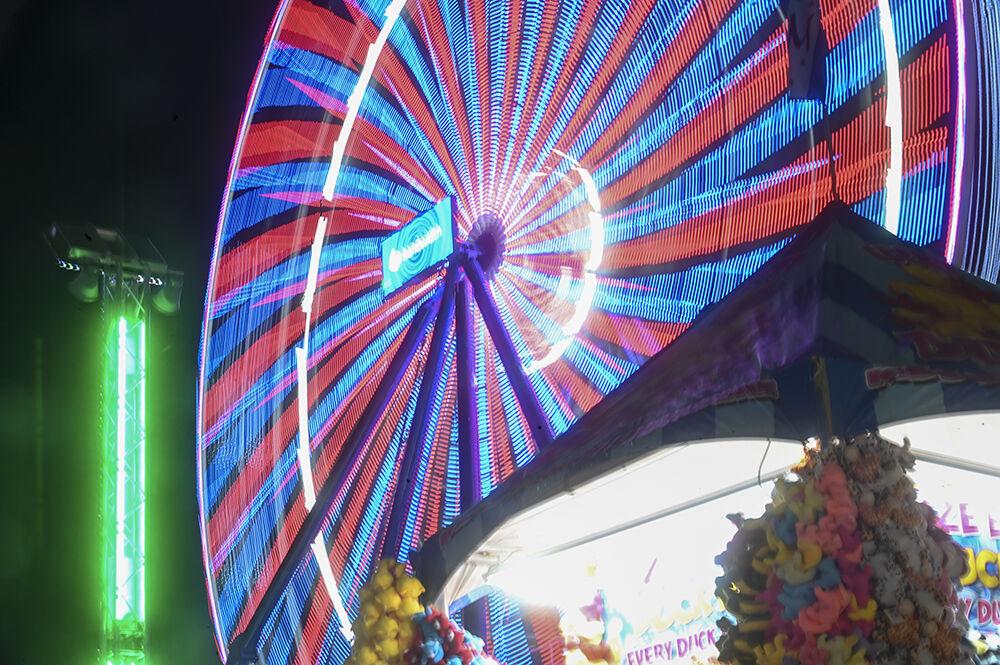 Fair attendees ride a Ferris Wheel at the North Carolina State Fair in Raleigh, on Thursday, Oct. 13, 2022. The NC State Fair was held Oct. 13-23.