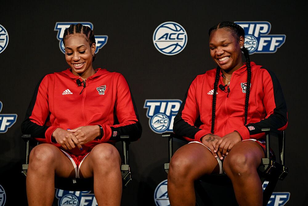 Senior wing Jakia Brown-Turner, left, and junior guard Diamond Johnson, right, laugh at one of head coach Wes Moore's jokes during the ACC Tipoff on Tuesday, Oct. 11, 2022 at The Westin Charlotte in Charlotte, North Carolina.&#160;The ACC Tipoff is an event that spans two days to promote the upcoming women and men's basketball seasons.&#160; Brown-Turner and Johnson spoke about the future of the NC State women's basketball team and how they plan to lead the team this season.