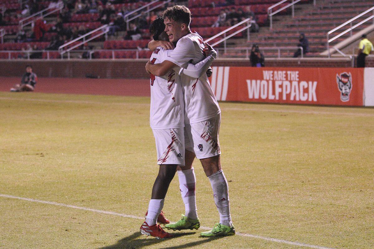 Freshman midfielder Drew Lovelace celebrates a goal with his teammate, junior forward, Junior Nare during the match against Radford on Tuesday, October 25, 2022 at Dail Soccer Field. NC State defeated Radford 2-0.