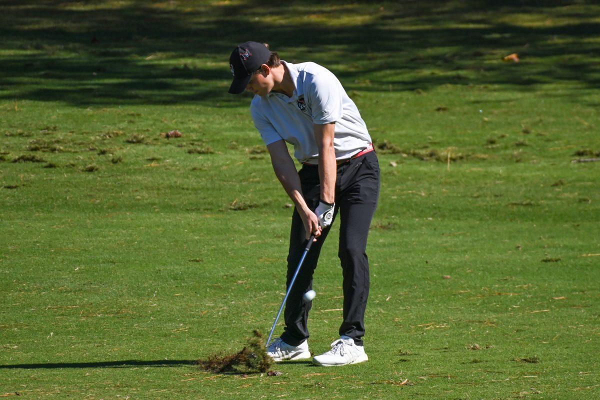 Senior Brandon Einstein chips the ball towards the green during the Wolfpack Intercollegiate tournament at Lonnie Poole Golf Course on Saturday, Oct. 15, 2022. Einstein tied for 28th with a score of 5-over. NC State tied for second place.