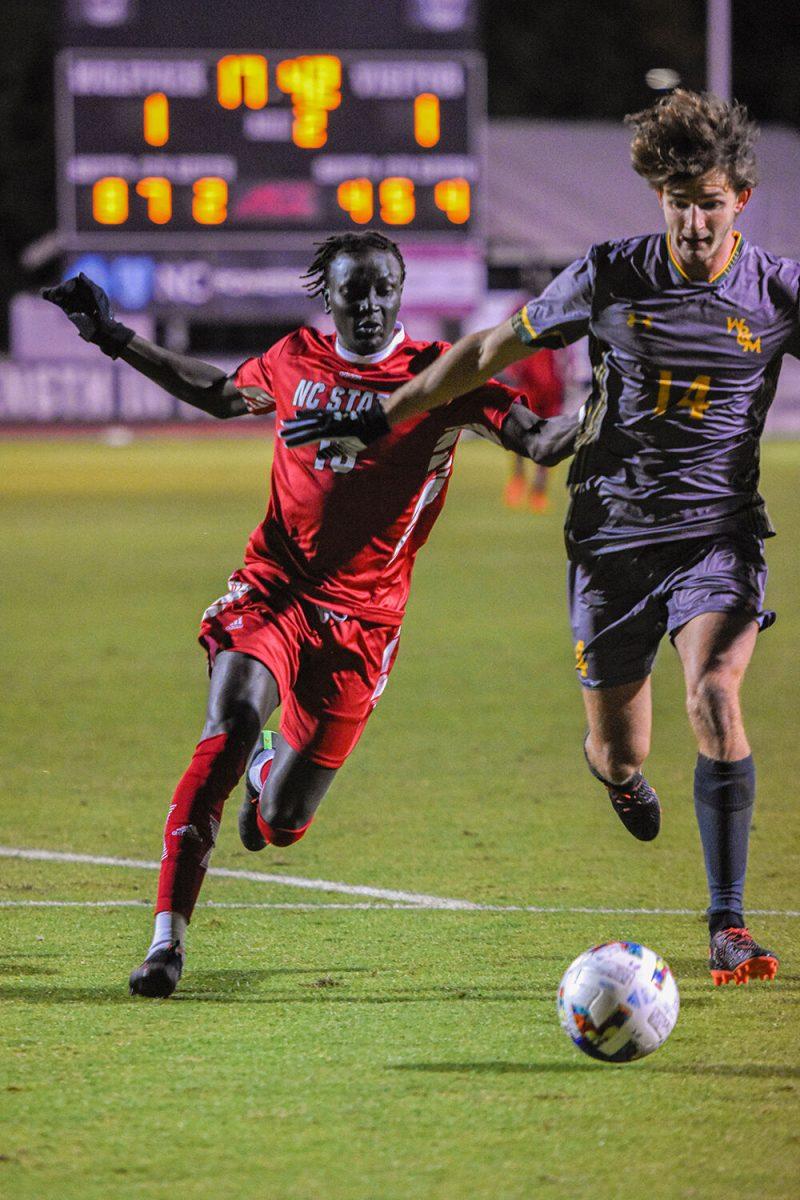 Senior forward Jeremiah Luoma fights for the ball during the Wolfpack's home soccer match against the William &amp; Mary Tribe on Tuesday, Oct. 18, 2022 at Dail Soccer Field. The Wolfpack beat the Tribe 2-1.