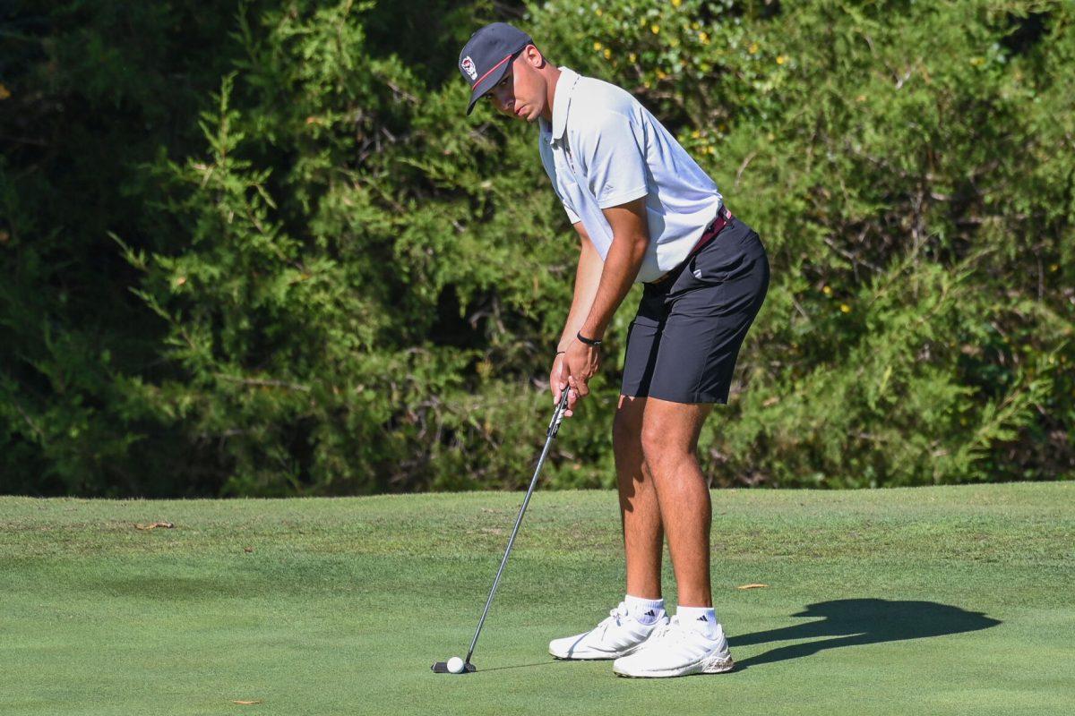 Junior Spencer Oxendine prepares to putt during the Wolfpack Intercollegiate tournament on Saturday, Oct. 15, 2022. Oxendine had a score of 9-over. NC State tied for second place.