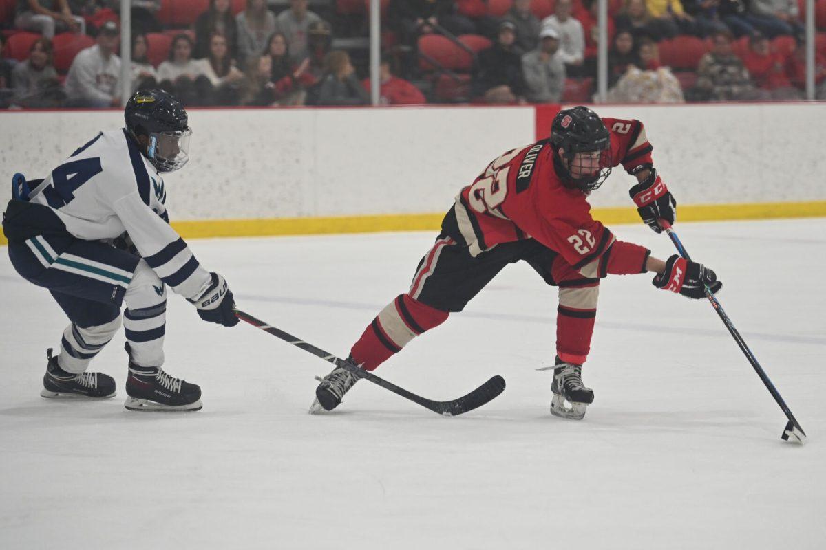 Sophomore forward Emery Oliver reaches for the puck during the game against UNC-Wilmington at Wake Competition Center on Friday, Oct. 14, 2022. Oliver had one goal. The Icepack won 4-1.