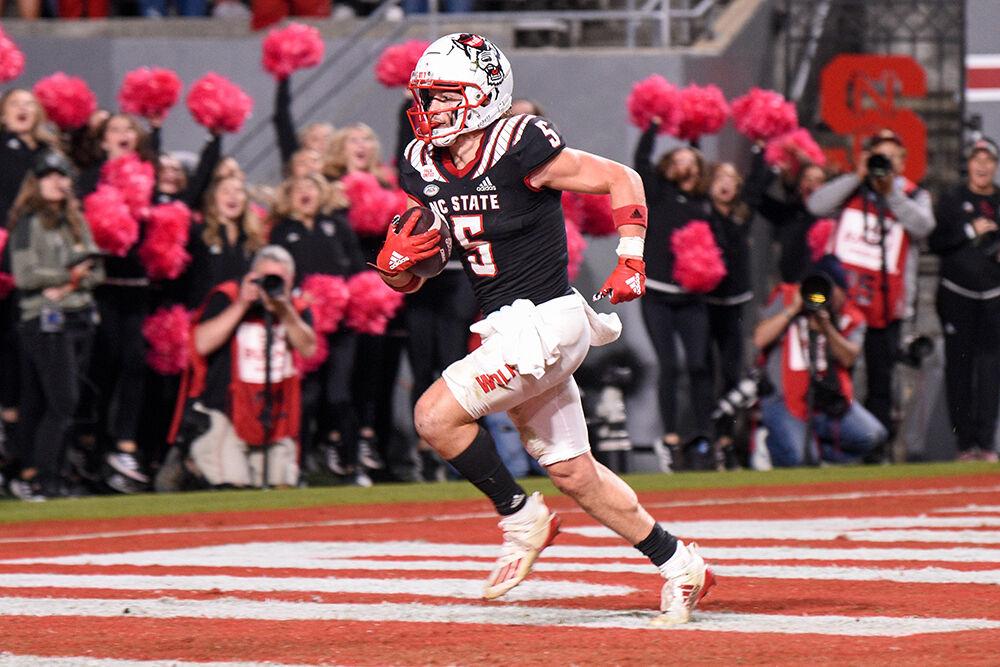 Graduate wide receiver Thayer Thomas scores a touchdown during the Wolfpack's game against the Virginia Tech Hokies on Thursday, Oct. 27, 2022 at Carter-Finley Stadium. The Wolfpack beat the Hokies 22-21.