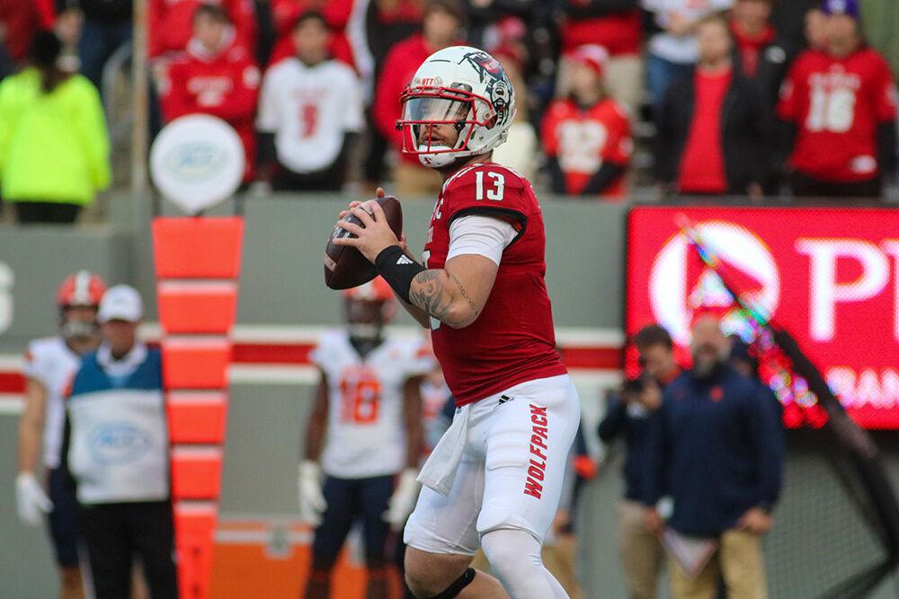 Redshirt sophomore quarterback Devin Leary looks for an open receiver at the game against the Syracuse Orange on Saturday, Nov. 20, 2021 at Carter-Finley Stadium. Leary threw for 303 yards and two touchdowns throughout the night. The Wolfpack won 41-17.