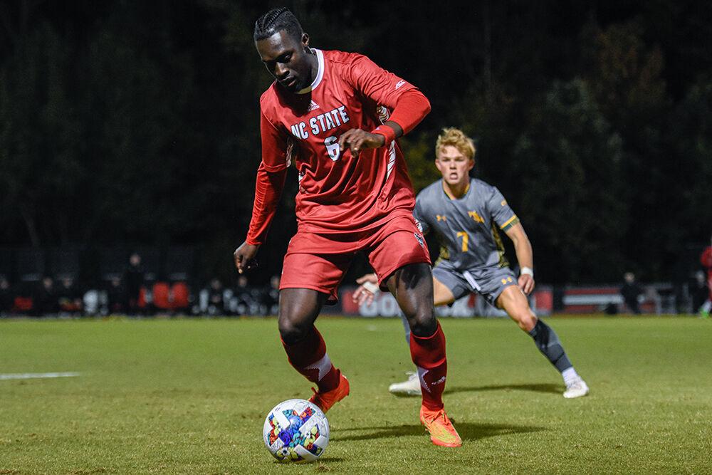 Senior defender Kendall Edwards dribbles the ball during the Wolfpack's home soccer match against the William &amp; Mary Tribe on Tuesday, Oct. 18, 2022 at Dail Soccer Field. The Wolfpack beat the Tribe 2-1.
